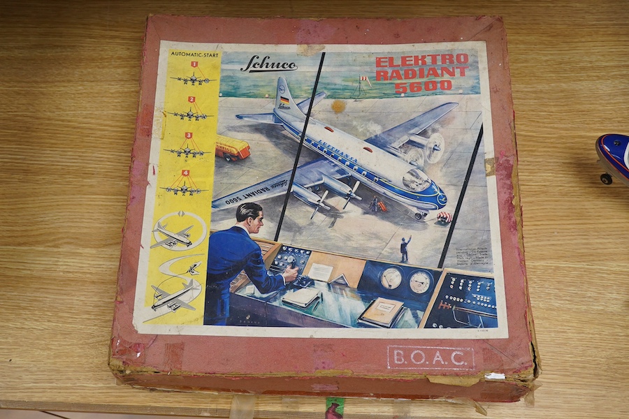 A boxed Schuco Elektro Radiant 5600 battery operated tinplate BOAC passenger aircraft, with instruction leaflet and steering wheel. Condition - poor to good, wear and damage to box and some tape repairs, aircraft general